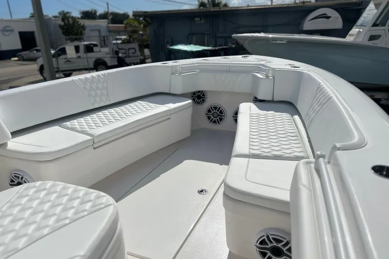  Yacht Photos Pics 2025 Contender 35 ST boat interior with white cushioned seating and built-in speakers.