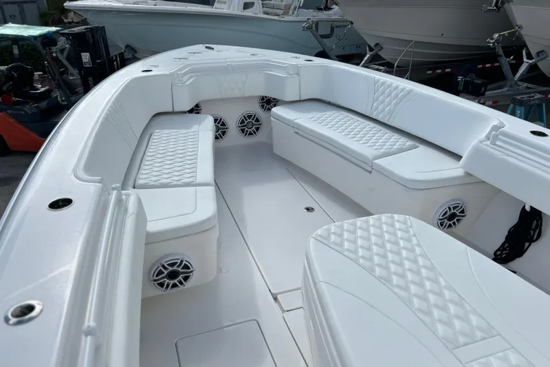  Yacht Photos Pics 2025 Contender 35 ST boat interior with white cushioned seating and speakers.