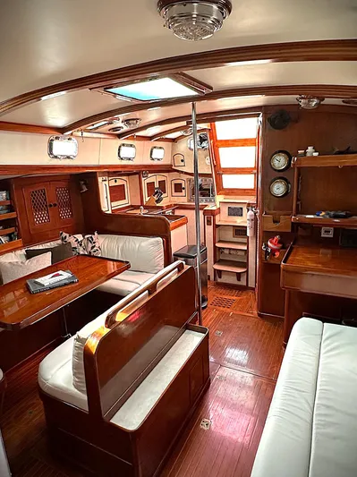 Alice Yacht Photos Pics Interior of 1983 Little Harbor 44 yacht with wooden furnishings and cozy seating area.