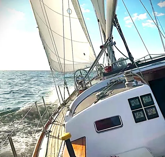 Alice Yacht Photos Pics Sailing on a 1983 Little Harbor 44 yacht with white sails and ocean waves.