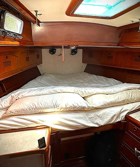 Alice Yacht Photos Pics Cozy cabin interior of 1983 Little Harbor 44 sailboat with wood finish and bedding.