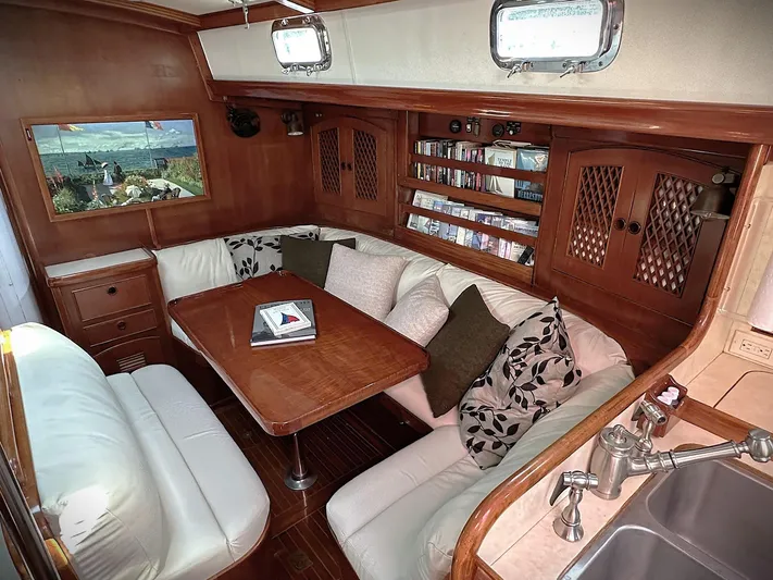 Alice Yacht Photos Pics Cozy interior of 1983 Little Harbor 44 yacht with wood paneling and plush seating.