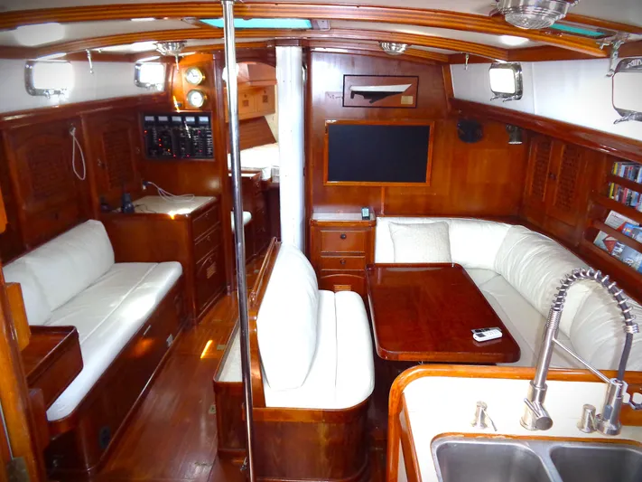 Alice Yacht Photos Pics Luxurious 1983 Little Harbor 44 yacht interior with wood finish and white seating.