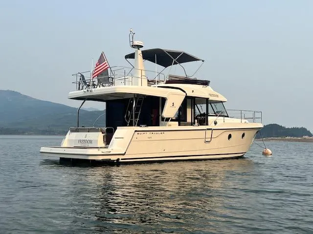 Freedom Yacht Photos Pics 2022 Beneteau Swift Trawler 41 Fly on calm water with American flag.