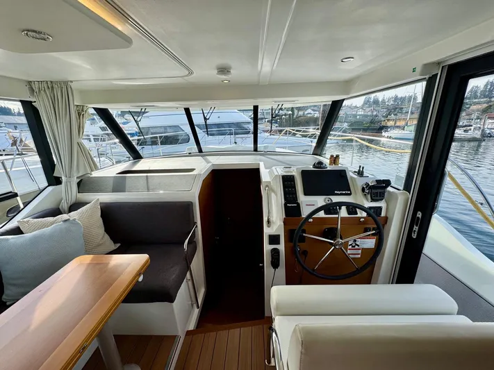 Freedom Yacht Photos Pics 2022 Beneteau Swift Trawler 41 Fly interior with helm, seating, and table.