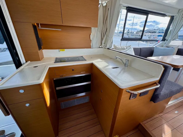 Freedom Yacht Photos Pics 2022 Beneteau Swift Trawler 41 Fly kitchen with modern appliances and wood cabinetry.