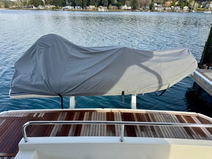 Freedom Yacht Photos Pics Covered boat on Beneteau Swift Trawler 41 Fly, 2022, docked by serene waters.