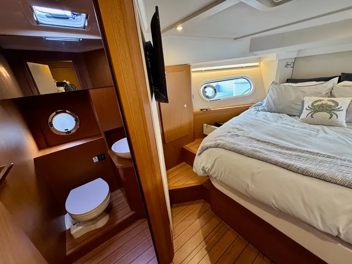 Freedom Yacht Photos Pics Interior of 2022 Beneteau Swift Trawler 41 Fly, featuring cozy bedroom and bathroom.