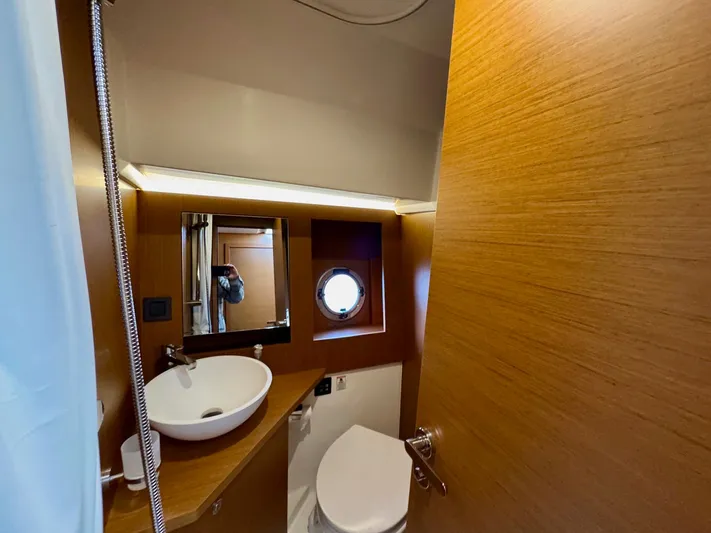 Freedom Yacht Photos Pics Bathroom interior of 2022 Beneteau Swift Trawler 41 Fly, featuring modern fixtures and wood finish.