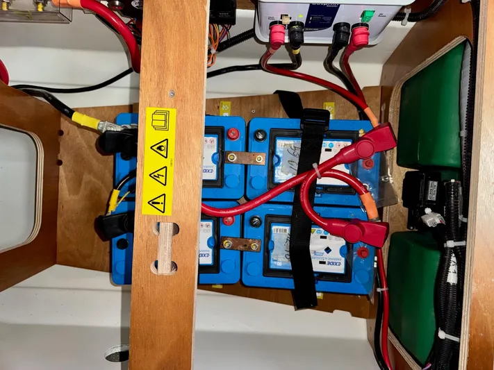 Freedom Yacht Photos Pics Battery compartment of 2022 Beneteau Swift Trawler 41 Fly with wiring and safety labels.