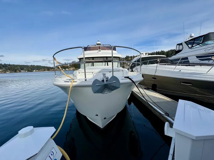 Freedom Yacht Photos Pics 2022 Beneteau Swift Trawler 41 Fly docked at marina, front view.