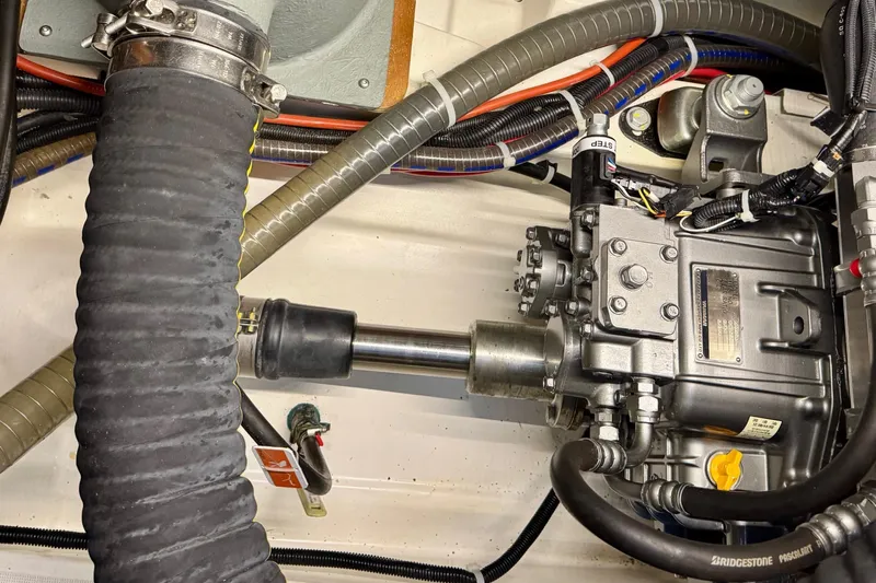 Freedom Yacht Photos Pics Engine room of 2022 Beneteau Swift Trawler 41 Fly, showcasing mechanical components and hoses.
