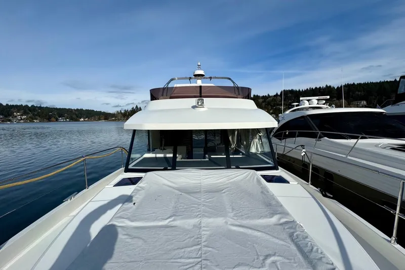 Freedom Yacht Photos Pics 2022 Beneteau Swift Trawler 41 Fly on calm water, showcasing sleek design and spacious deck.