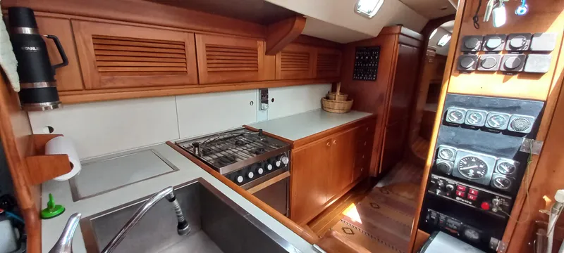 Oya Yacht Photos Pics Interior of 1989 Van De Stadt 52 yacht, featuring a wooden kitchen and control panel.