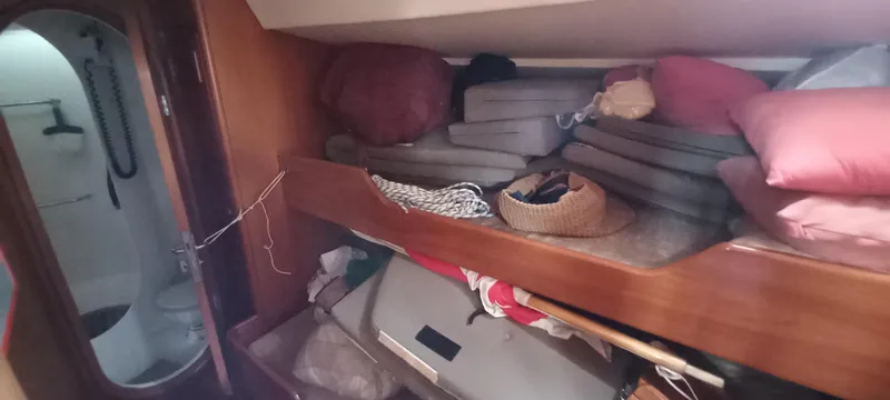 Oya Yacht Photos Pics Interior cabin of 1989 Van De Stadt 52 yacht with storage and cushions.
