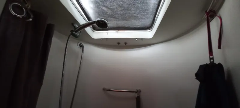 Oya Yacht Photos Pics Interior of 1989 Van De Stadt 52 yacht bathroom with showerhead and skylight.