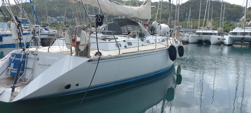Oya Yacht Photos Pics Sailing yacht Van De Stadt 52, 1989 model, docked in a marina with other boats.