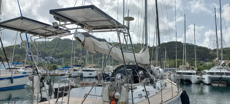 Oya Yacht Photos Pics Sailboat in marina, Van De Stadt 52, 1989 model, with solar panels and scenic background.