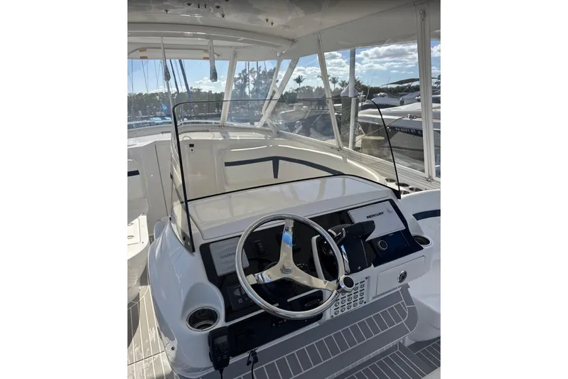  Yacht Photos Pics 2015 Intrepid 400 Cuddy boat helm with steering wheel and navigation controls.