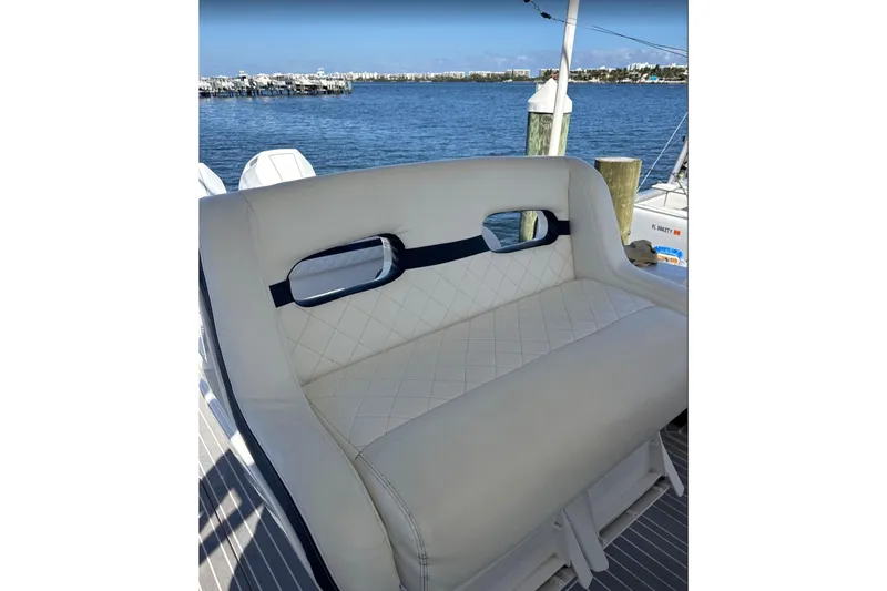  Yacht Photos Pics Luxury seating on 2015 Intrepid 400 Cuddy boat, docked by the water.