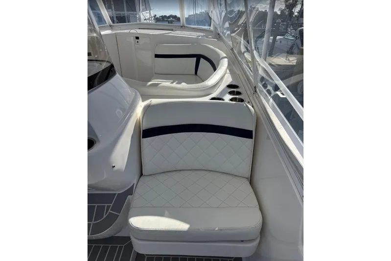  Yacht Photos Pics 2015 Intrepid 400 Cuddy interior with white cushioned seating and cup holders.