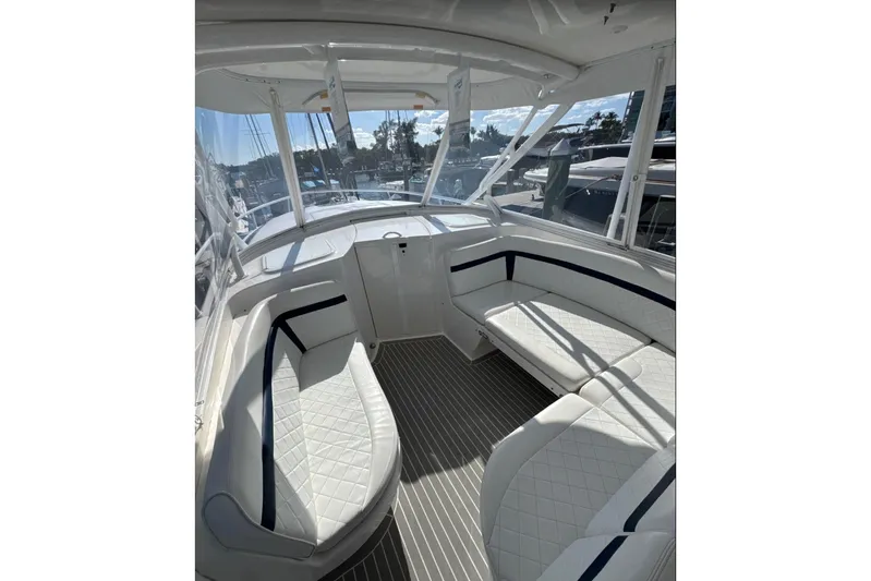  Yacht Photos Pics Interior of 2015 Intrepid 400 Cuddy boat with white seating and panoramic windows.