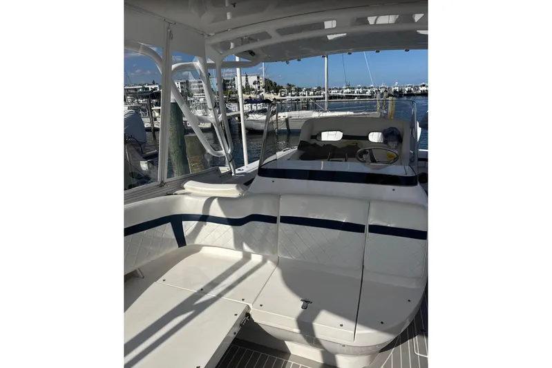  Yacht Photos Pics 2015 Intrepid 400 Cuddy boat interior with seating and helm, docked at marina.