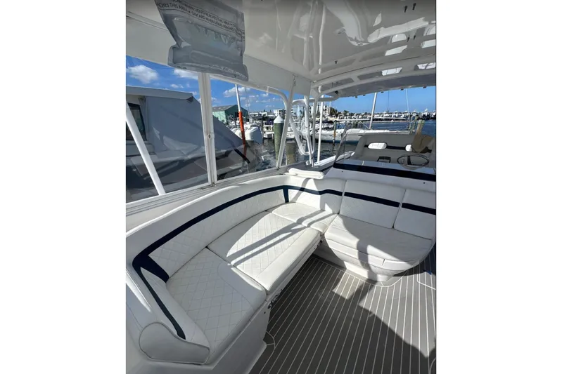  Yacht Photos Pics 2015 Intrepid 400 Cuddy interior with white seating and marina view.
