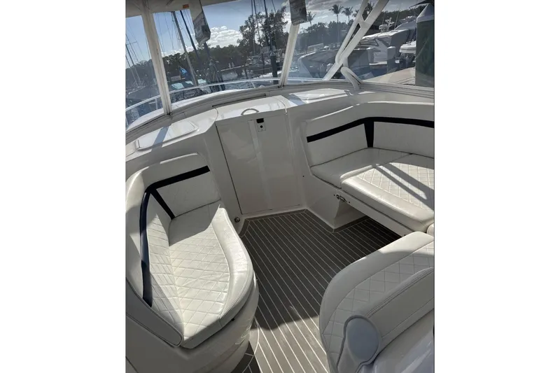 Yacht Photos Pics Interior of a 2015 Intrepid 400 Cuddy boat with white seating and striped flooring.