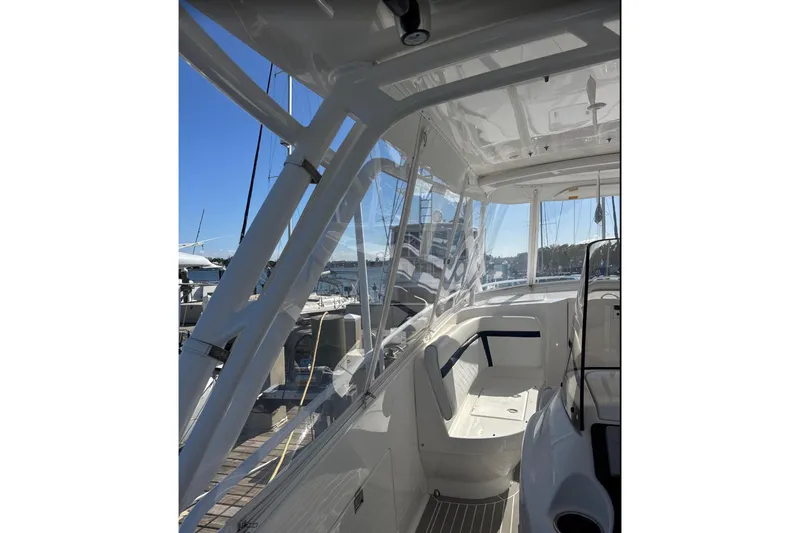  Yacht Photos Pics 2015 Intrepid 400 Cuddy boat interior with clear canopy and seating area.