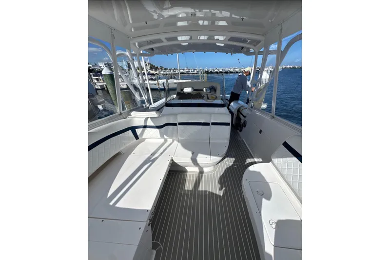 Yacht Photos Pics 2015 Intrepid 400 Cuddy boat interior with seating and helm, docked at marina.
