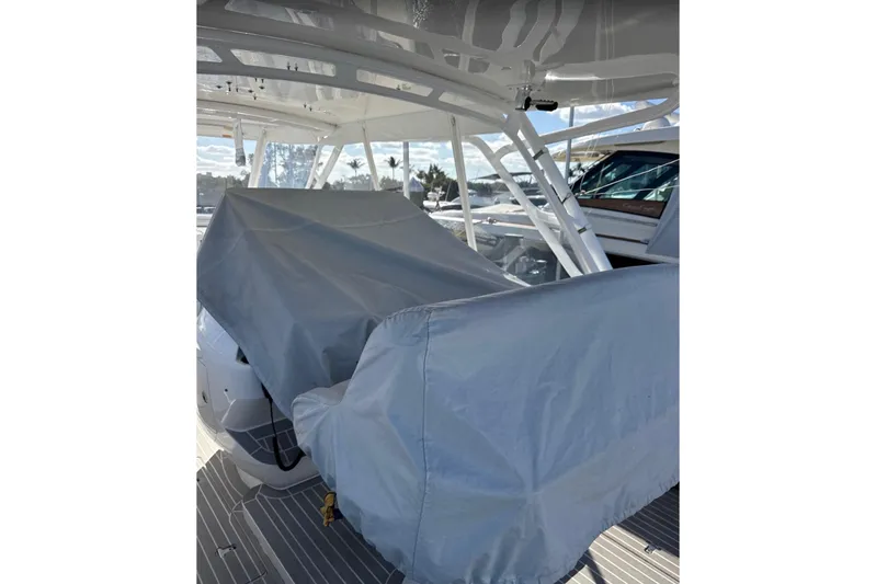  Yacht Photos Pics 2015 Intrepid 400 Cuddy boat interior with protective covers on seating.
