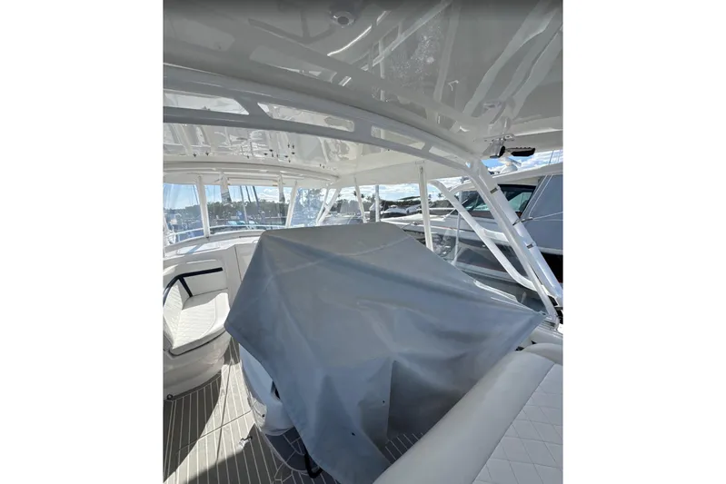  Yacht Photos Pics 2015 Intrepid 400 Cuddy interior with covered seating, showcasing sleek design and spacious layout.