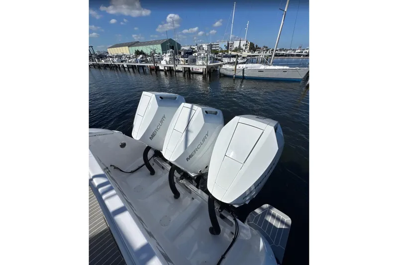  Yacht Photos Pics 2015 Intrepid 400 Cuddy with triple Mercury outboard engines docked at marina.