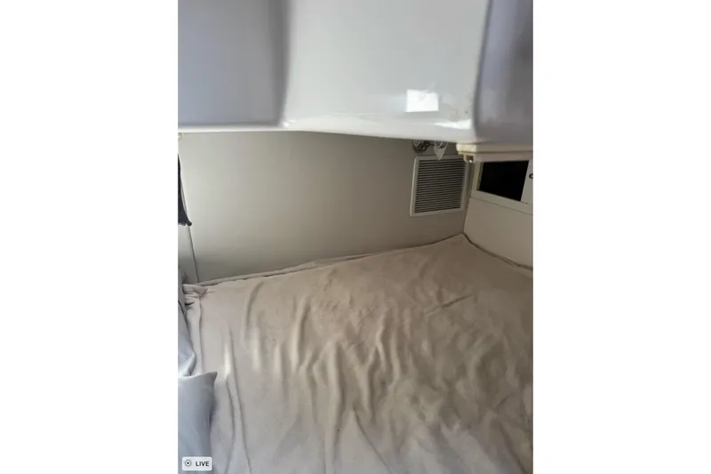  Yacht Photos Pics 2015 Intrepid 400 Cuddy cabin interior with beige bedding and wall vent.