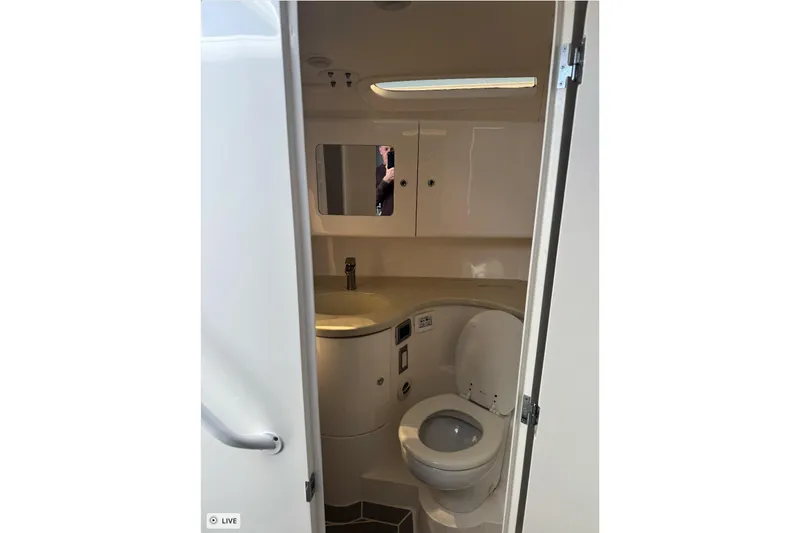  Yacht Photos Pics 2015 Intrepid 400 Cuddy boat bathroom interior with sink, toilet, and mirror.
