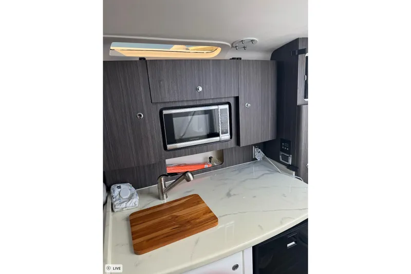  Yacht Photos Pics Modern kitchen area in 2015 Intrepid 400 Cuddy boat with microwave and cutting board.