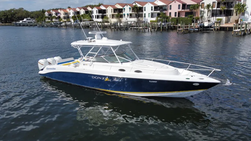 Singularity Yacht Photos Pics 2006 Donzi 38 ZSF boat on water near colorful waterfront homes.