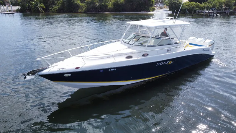 Singularity Yacht Photos Pics 2006 Donzi 38 ZSF boat on calm water, featuring sleek design and white-blue color scheme.