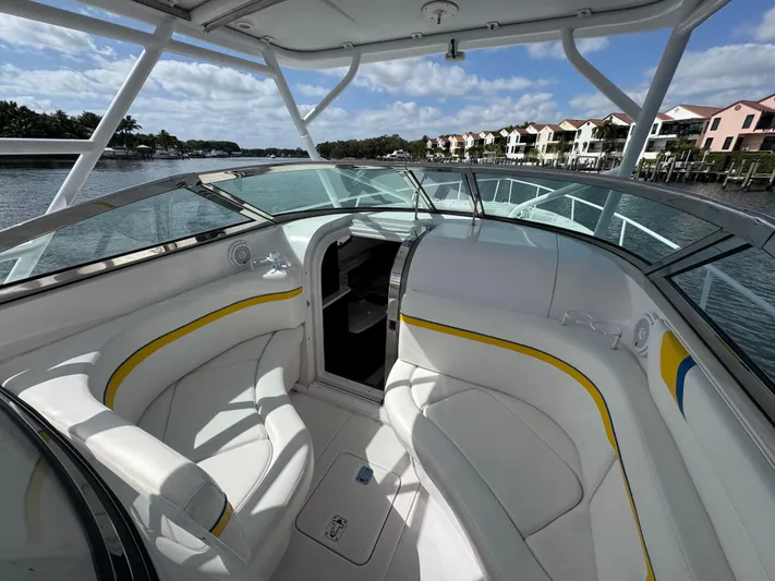 Singularity Yacht Photos Pics 2006 Donzi 38 ZSF boat interior with white seating, yellow accents, and waterfront view.