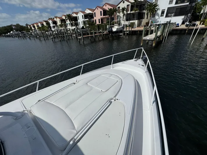 Singularity Yacht Photos Pics 2006 Donzi 38 ZSF boat docked near waterfront homes under a partly cloudy sky.