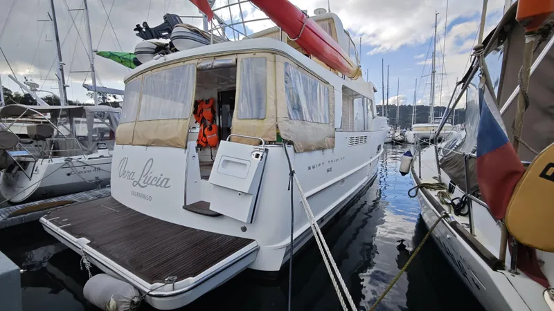 Beneteau Swift Trawler 52 Yacht Photos Pics 2011 Beneteau Swift Trawler 52 docked at marina, rear view with lifebuoys.