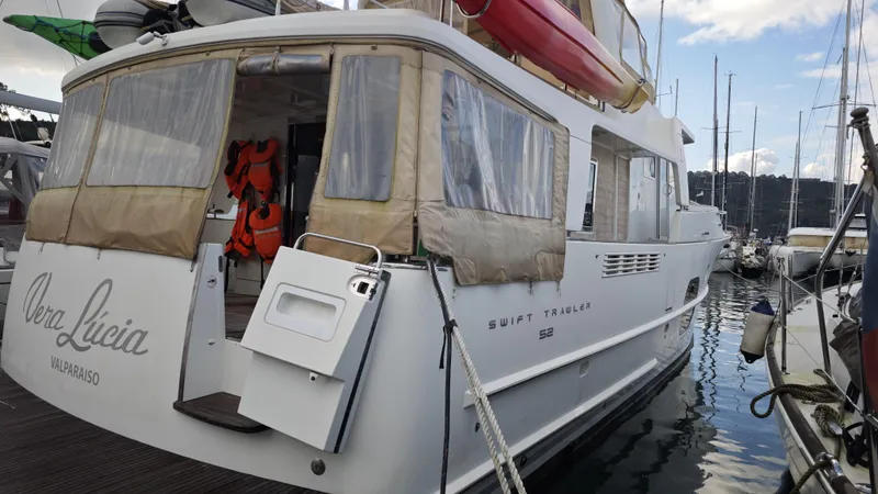 Beneteau Swift Trawler 52 Yacht Photos Pics 2011 Beneteau Swift Trawler 52 docked, featuring outdoor gear and lifebuoys.