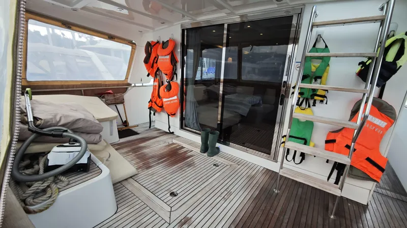 Beneteau Swift Trawler 52 Yacht Photos Pics 2011 Beneteau Swift Trawler 52 interior with life jackets and wooden flooring.