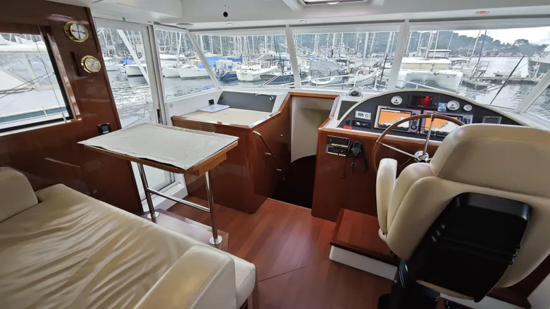 Beneteau Swift Trawler 52 Yacht Photos Pics Interior of 2011 Beneteau Swift Trawler 52 with helm, seating, and marina view.