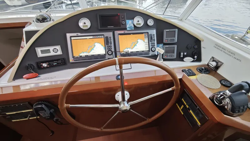 Beneteau Swift Trawler 52 Yacht Photos Pics Helm of 2011 Beneteau Swift Trawler 52 with navigation screens and controls.