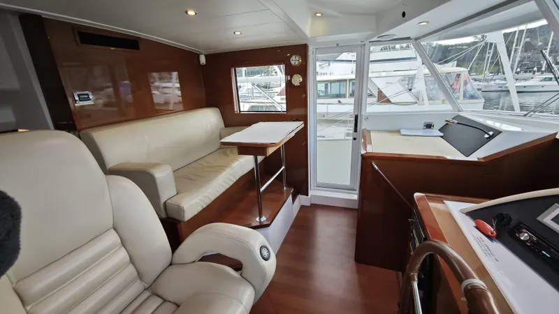 Beneteau Swift Trawler 52 Yacht Photos Pics Luxurious interior of 2011 Beneteau Swift Trawler 52 with leather seating and wooden accents.