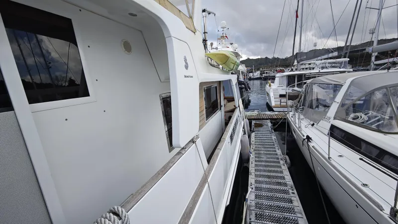 Beneteau Swift Trawler 52 Yacht Photos Pics 2011 Beneteau Swift Trawler 52 docked at marina, surrounded by other boats.