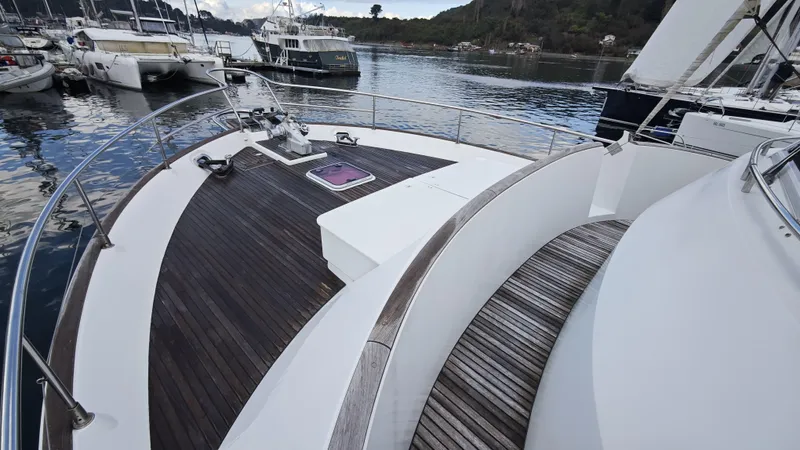 Beneteau Swift Trawler 52 Yacht Photos Pics 2011 Beneteau Swift Trawler 52 yacht deck with wooden flooring, docked in a marina.