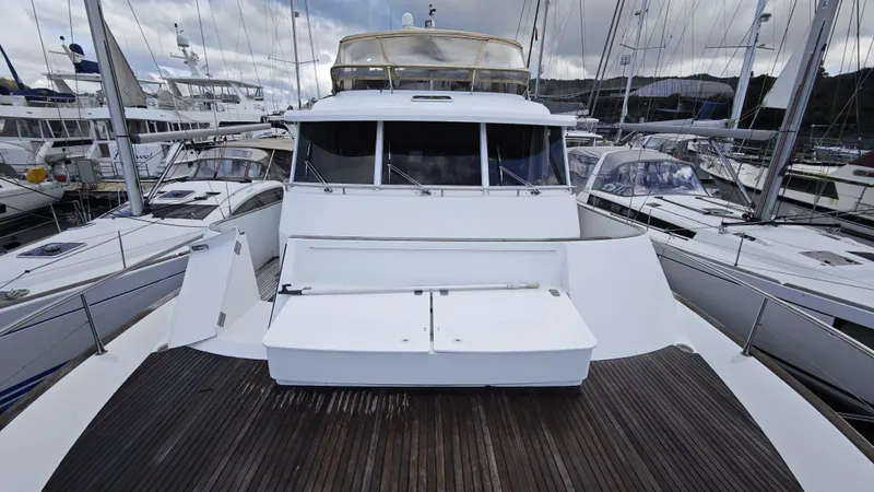 Beneteau Swift Trawler 52 Yacht Photos Pics 2011 Beneteau Swift Trawler 52 docked among sailboats, showcasing its spacious deck.